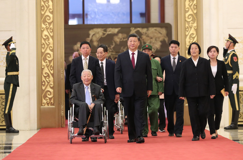 2019年9月29日，中華人民共和國國家勛章和國家榮譽稱號頒授儀式在北京人民大會堂金色大廳隆重舉行。這是中共中央總書記、國家主席、中央軍委主席習近平同國家勛章和國家榮譽稱號獲得者一同步入會場。新華社記者 丁海濤 攝